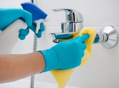 Domestic cleaner tidying a modern apartment near Westbourne Grove